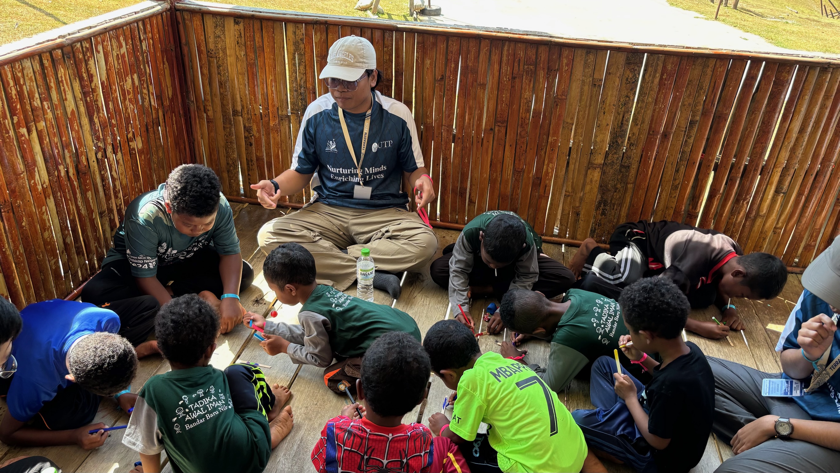 Students interacting with Orang Asli children